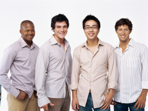 portrait of four young men smiling